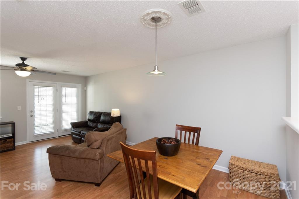 8246 Rudolph Road Charlotte, NC 28216 - Photo 8 of 29 a living room with furniture and a wooden floor