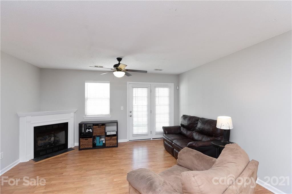 8246 Rudolph Road Charlotte, NC 28216 - Photo 10 of 29 a living room with furniture and a fireplace
