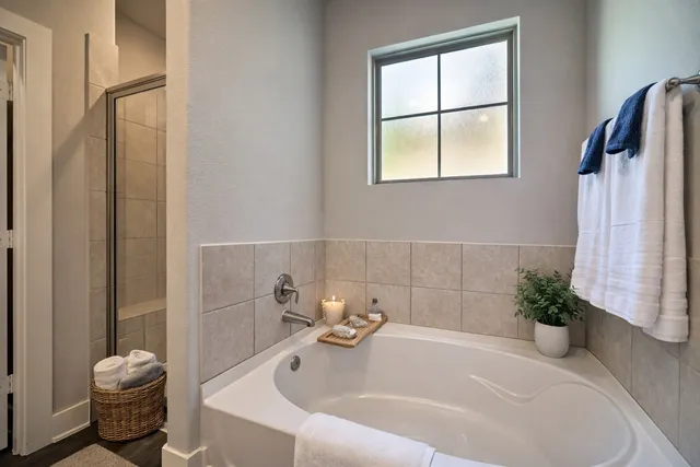 a white bath tub sitting next to a white toilet and a shower