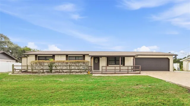 a front view of house with yard and outdoor seating