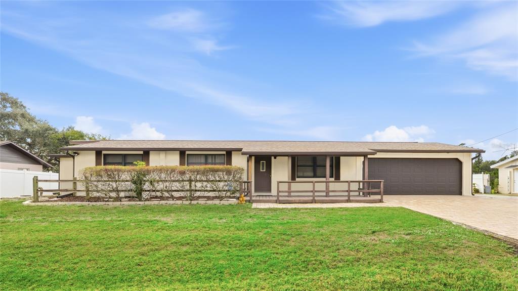 a front view of house with yard and outdoor seating