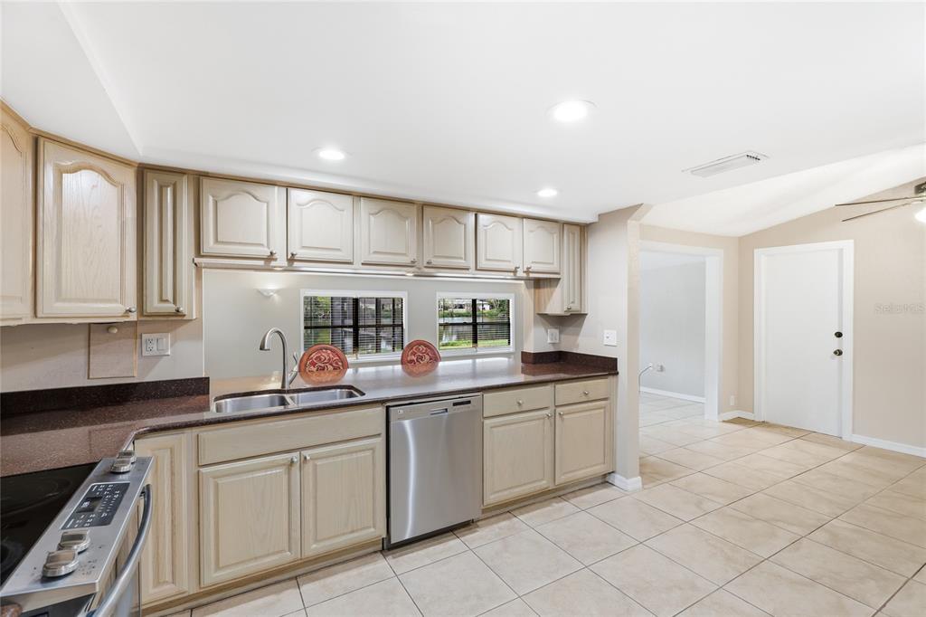 3452 Desoto Road Sarasota, FL 34235 - Photo 11 of 42 a kitchen with white cabinets and white appliances