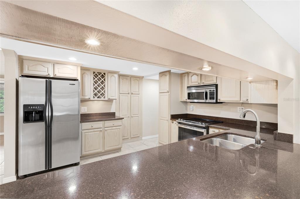 3452 Desoto Road Sarasota, FL 34235 - Photo 12 of 42 a kitchen with stainless steel appliances a refrigerator and a stove top oven