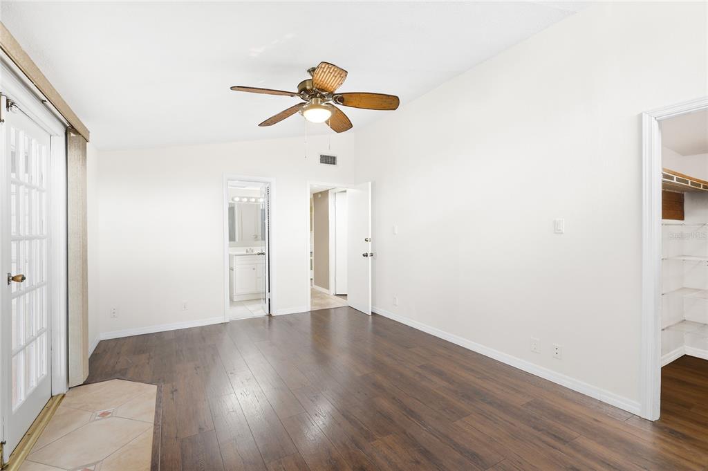 3452 Desoto Road Sarasota, FL 34235 - Photo 21 of 42 a view of an empty room with wooden floor and a window