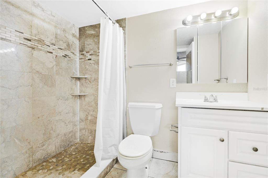 3452 Desoto Road Sarasota, FL 34235 - Photo 22 of 42 a bathroom with a sink toilet and shower