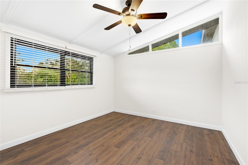 3452 Desoto Road Sarasota, FL 34235 - Photo 23 of 42 a view of an empty room with wooden floor and a window