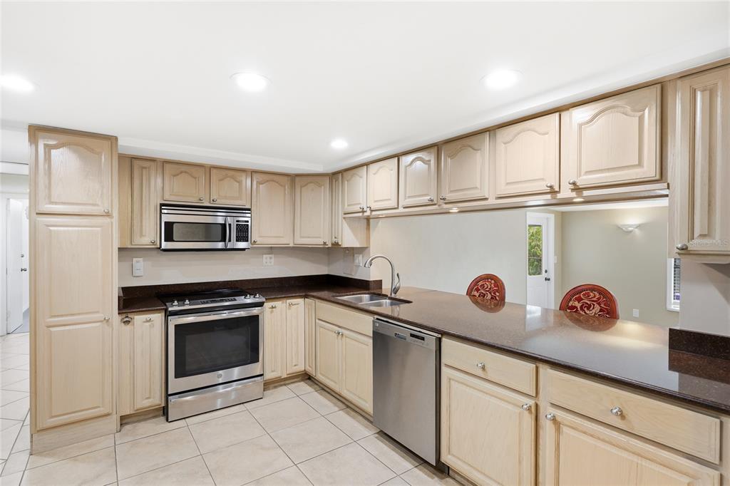 3452 Desoto Road Sarasota, FL 34235 - Photo 10 of 42 a kitchen with white cabinets and sink