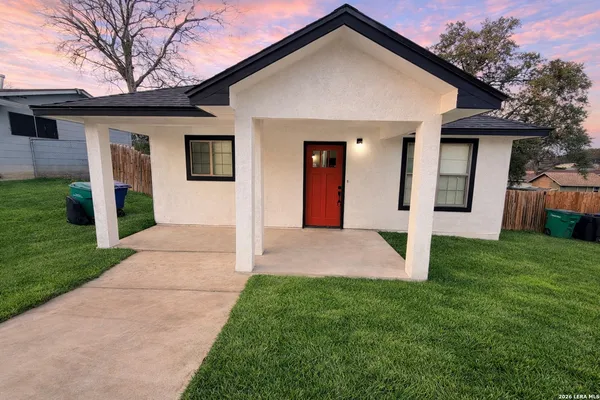 a front view of house with yard and green space