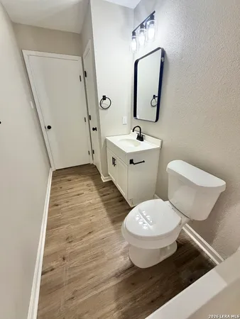 a white toilet sitting next to a bathroom sink