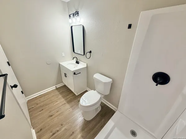 a bathroom with a toilet sink and mirror