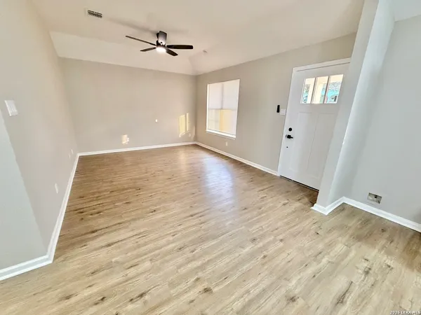 wooden floor in an empty room with a window