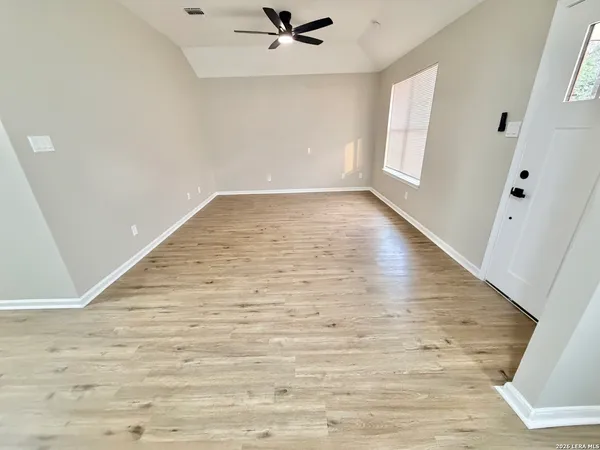 wooden floor in an empty room with a window