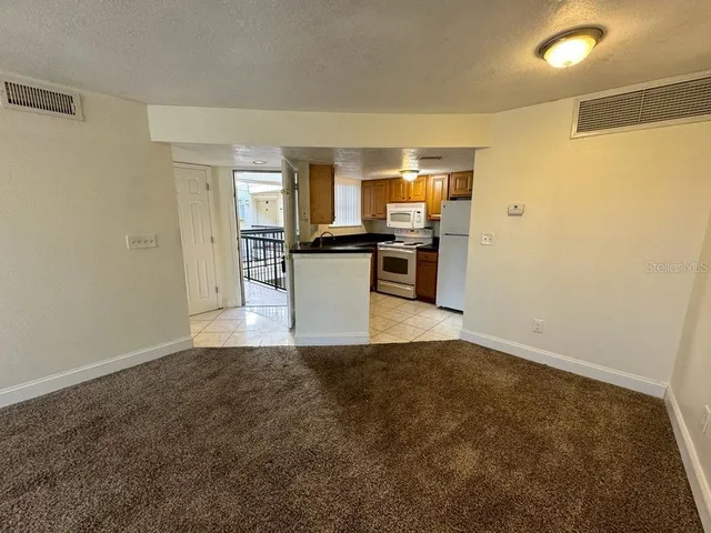a view of a kitchen with a sink and dishwasher a refrigerator with wooden floor