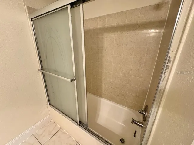a bathroom with a glass shower door