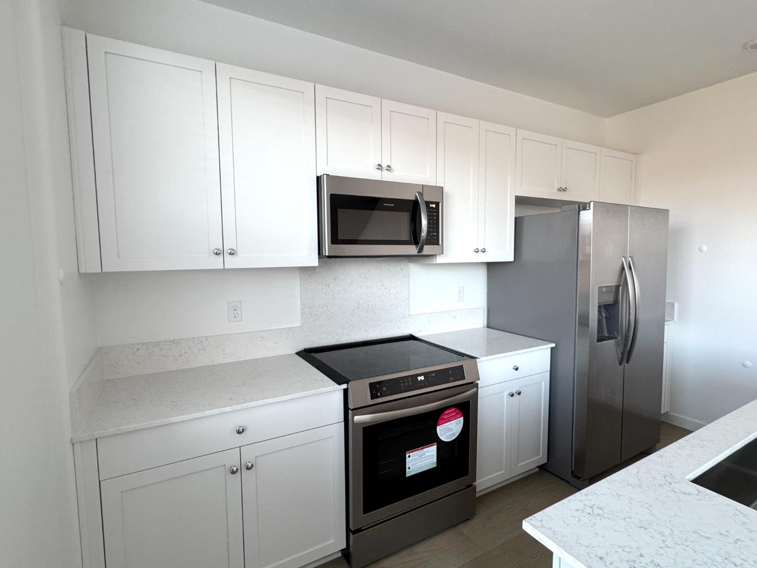 8524 Anker Way Elk Grove, CA 95757 - Photo 11 of 37 a kitchen with stainless steel appliances a stove a microwave and a refrigerator