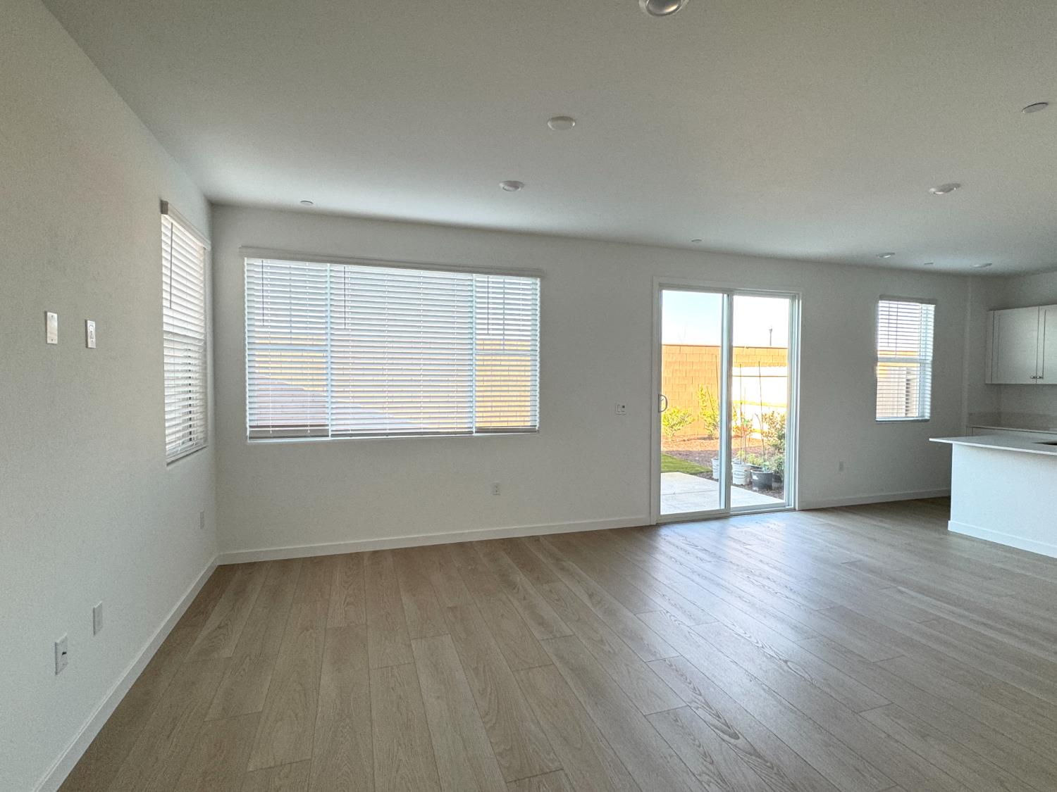 8524 Anker Way Elk Grove, CA 95757 - Photo 12 of 37 an empty room with wooden floor and windows