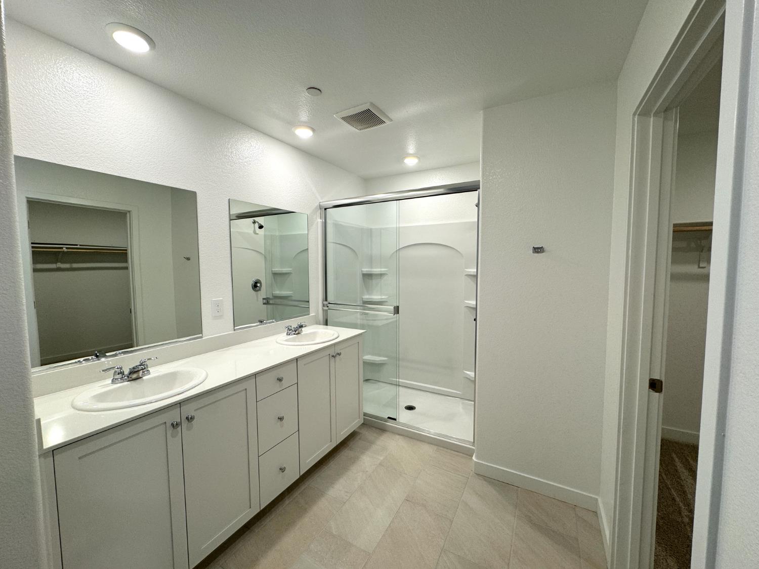8524 Anker Way Elk Grove, CA 95757 - Photo 16 of 37 a bathroom with a double vanity sink mirror double and shower