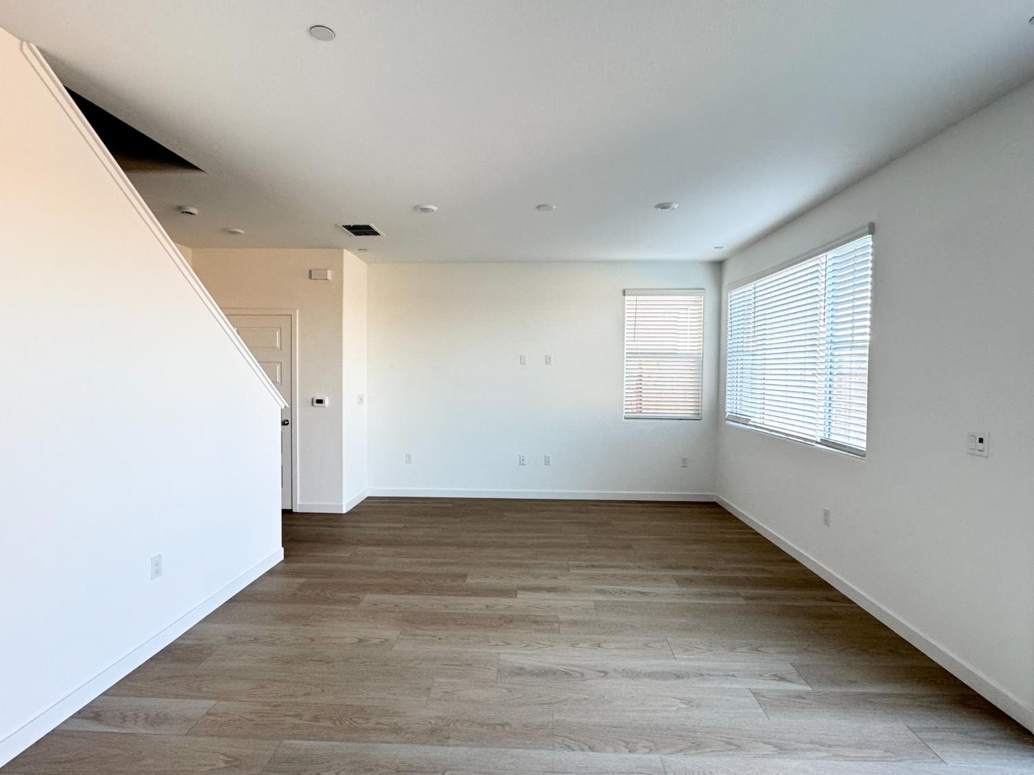 8524 Anker Way Elk Grove, CA 95757 - Photo 10 of 37 a view of a big room with wooden floor and windows