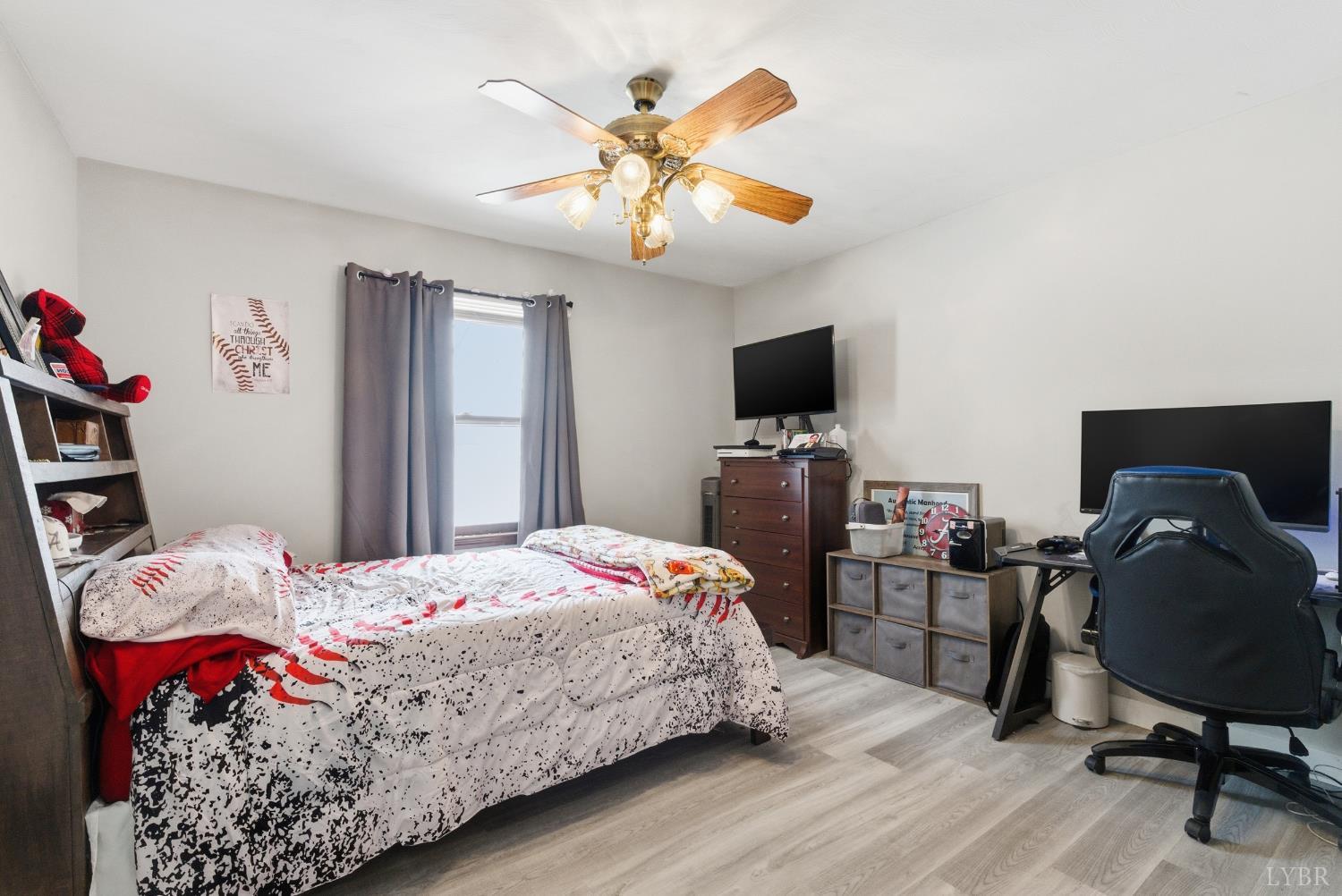 5225 Blue Ridge Drive Gretna, VA 24557 - Photo 14 of 28 a bedroom with a bed and a chandelier