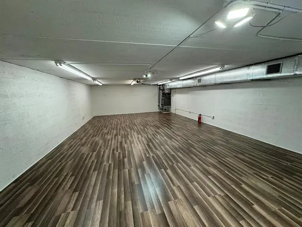 a view of a room with wooden floor