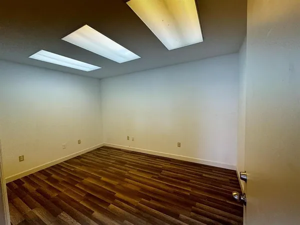 a view of room with wooden floor