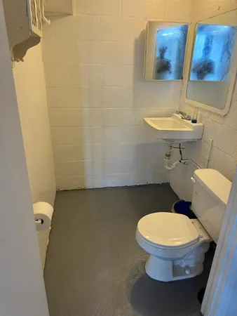 a white toilet sitting next to a bathroom sink