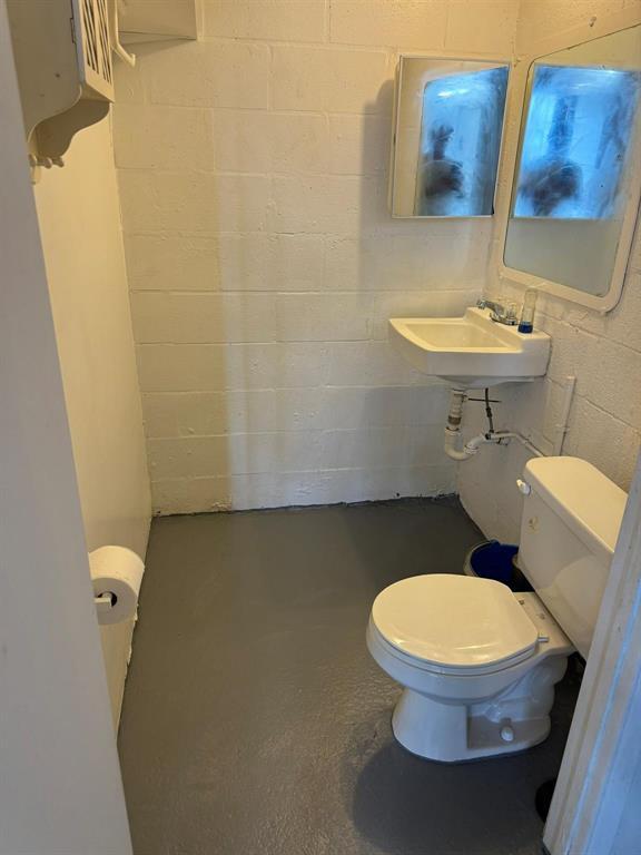 1773 Blount Road, Unit 313 Pompano Beach, FL 33069 - Photo 5 of 8 a white toilet sitting next to a bathroom sink