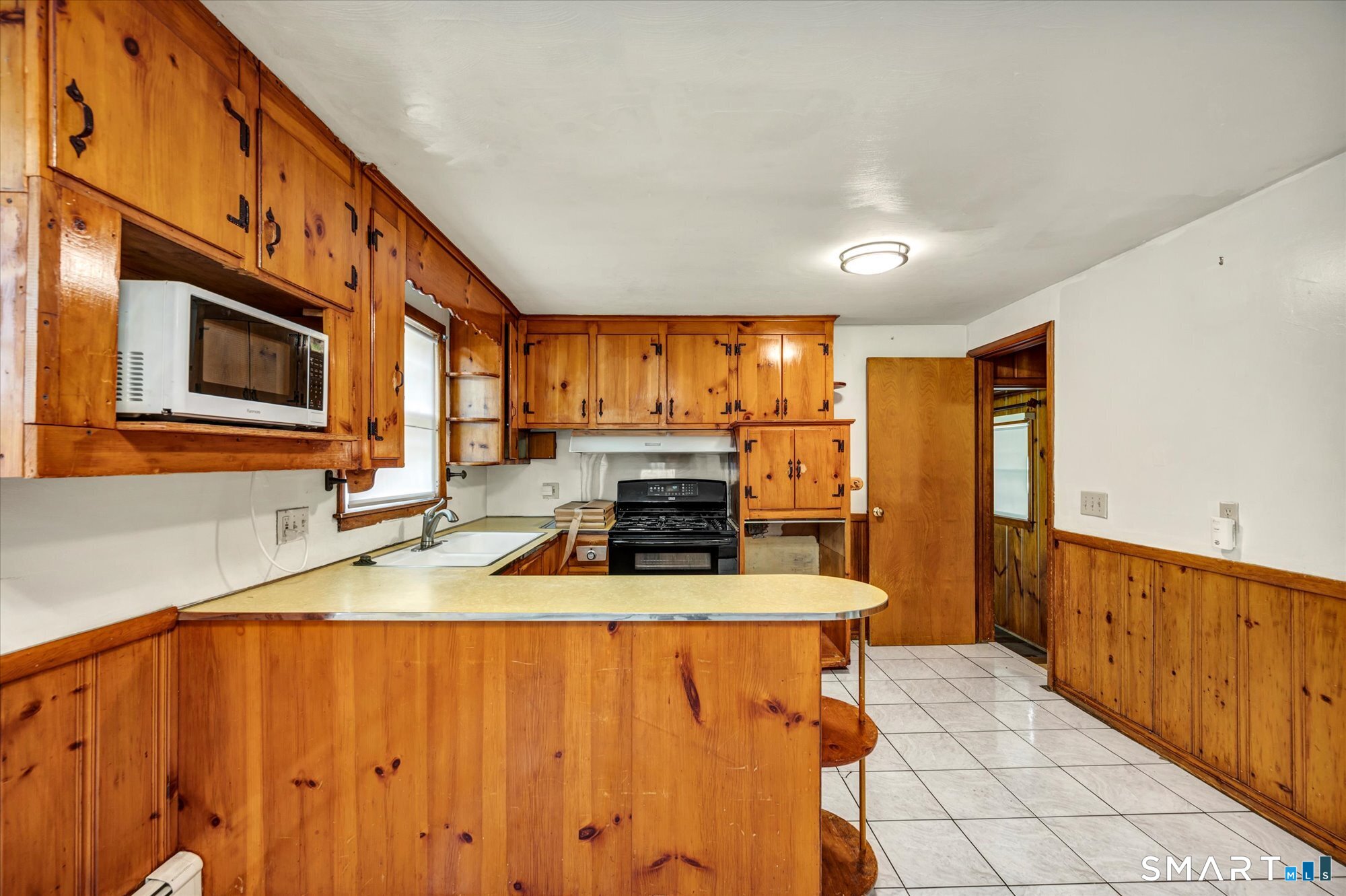 740 Rainbow Road Windsor, CT 06095 - Photo 15 of 40 a kitchen with stainless steel appliances a stove a sink and a microwave