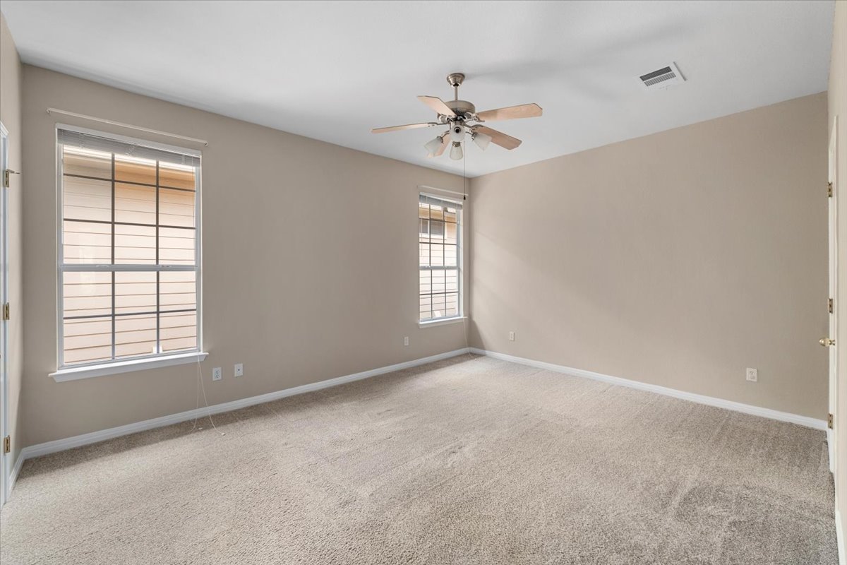 11000 Anderson Mill Road, Unit 11 Austin, TX 78750 - Photo 11 of 34 A spacious bedroom awaits, featuring comfortable carpeting and ample natural light.