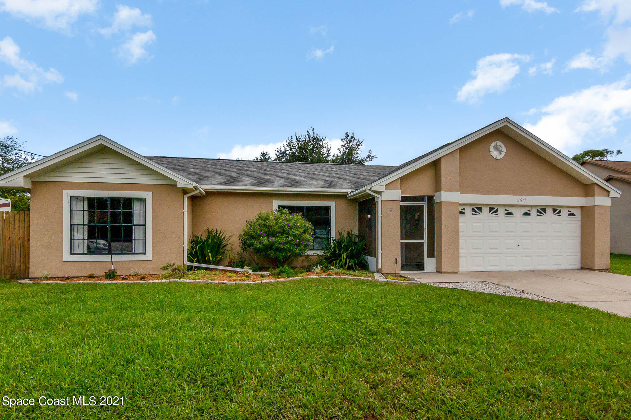 5617 Flint Road Cocoa, FL 32927 - Photo 1 of 25 a front view of a house with a garden and yard