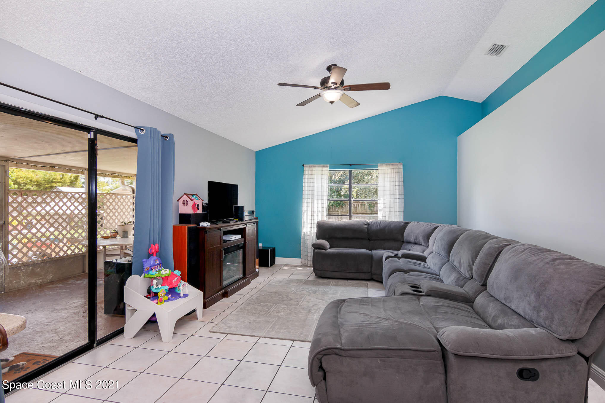 5617 Flint Road Cocoa, FL 32927 - Photo 11 of 25 a living room with furniture and a flat screen tv