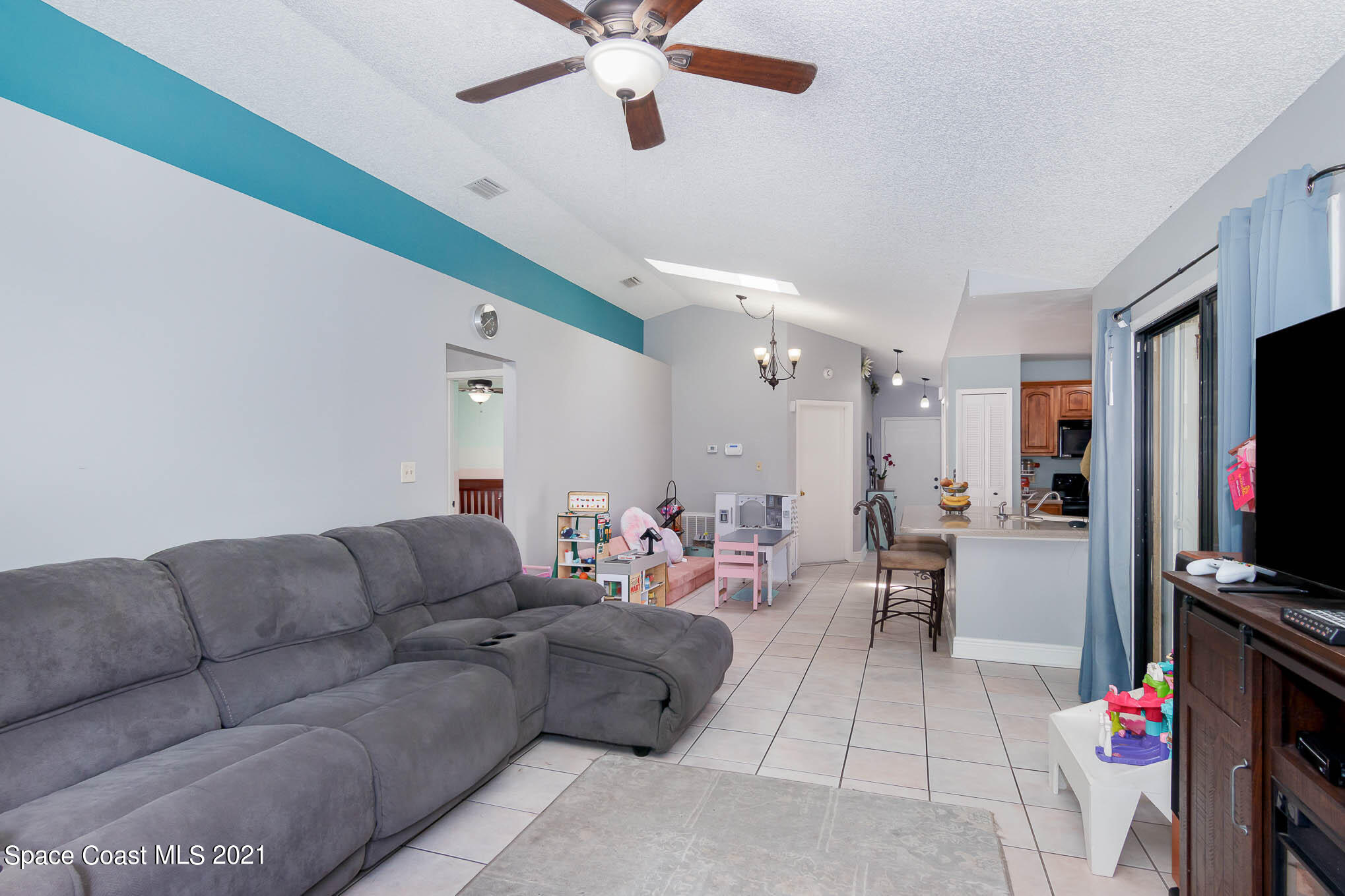 5617 Flint Road Cocoa, FL 32927 - Photo 12 of 25 a living room with furniture and a flat screen tv