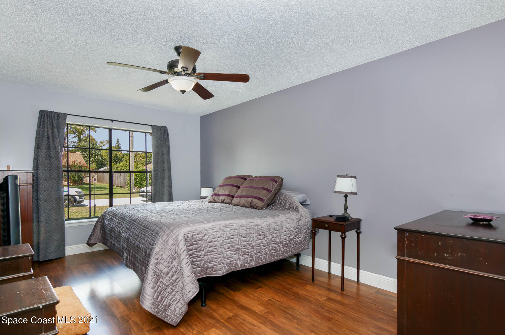 5617 Flint Road Cocoa, FL 32927 - Photo 13 of 25 a bedroom with a bed and wooden floor
