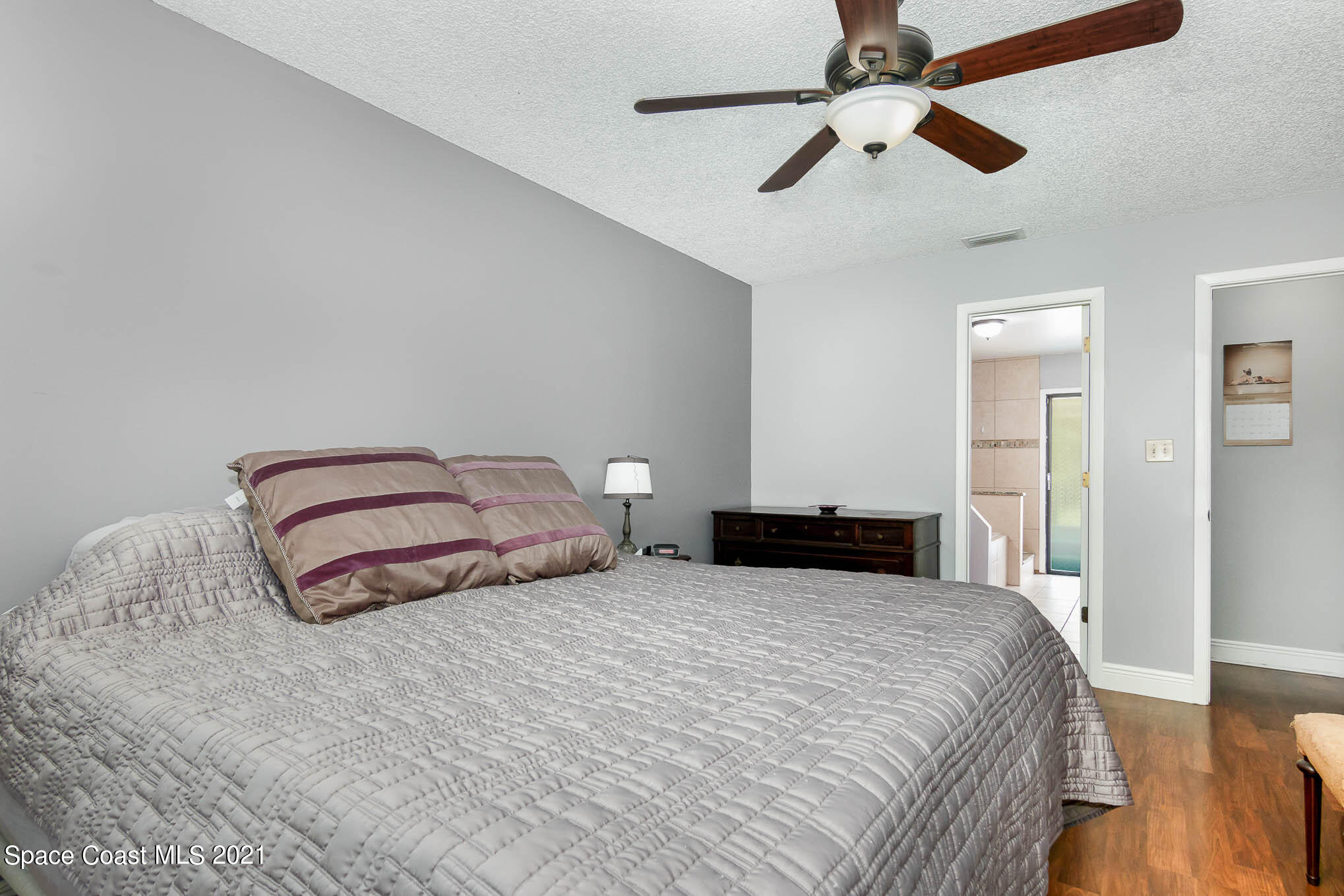 5617 Flint Road Cocoa, FL 32927 - Photo 14 of 25 a bedroom with a bed and ceiling fan