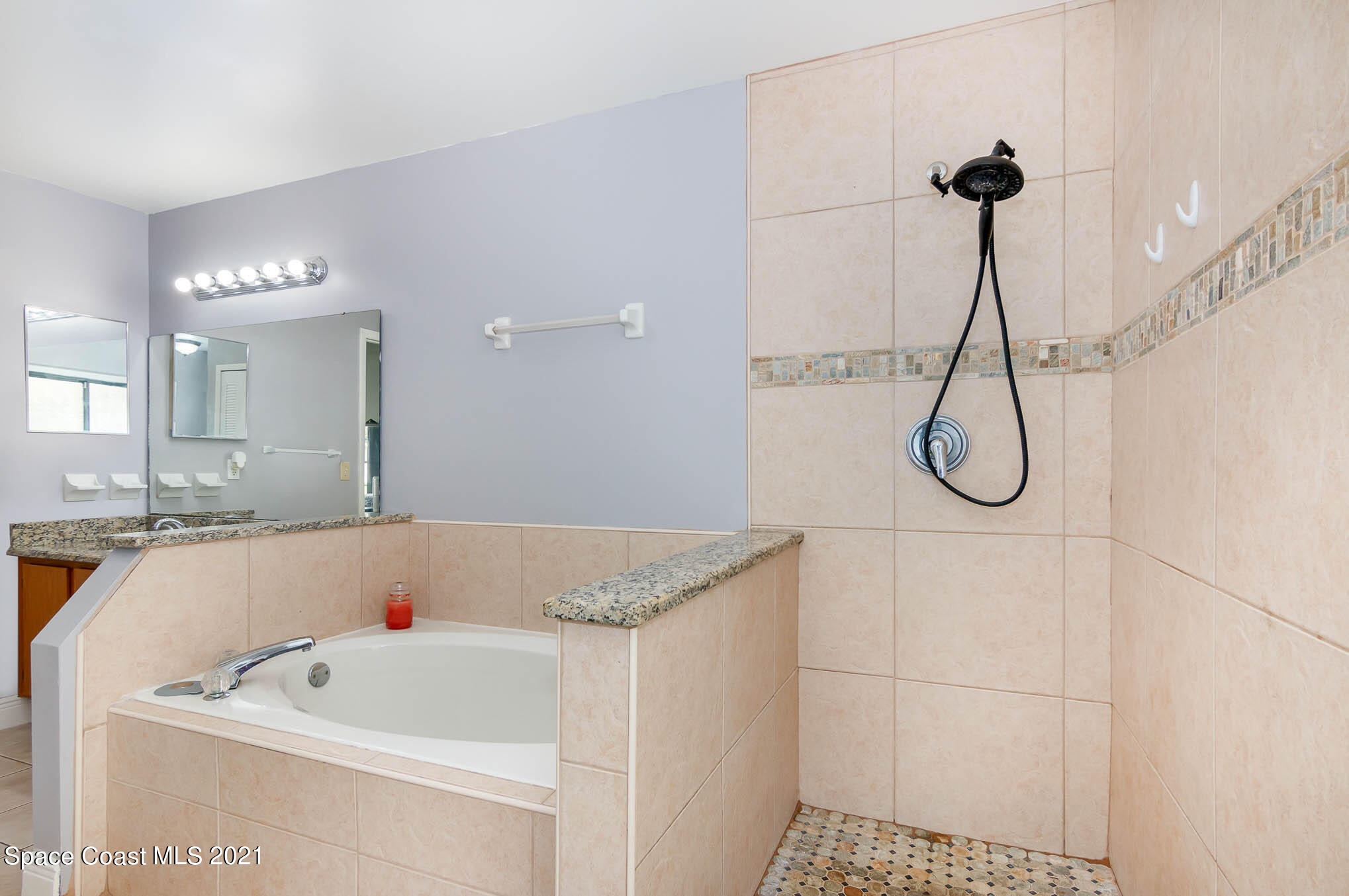 5617 Flint Road Cocoa, FL 32927 - Photo 16 of 25 a bathroom with a bath tub and a shower