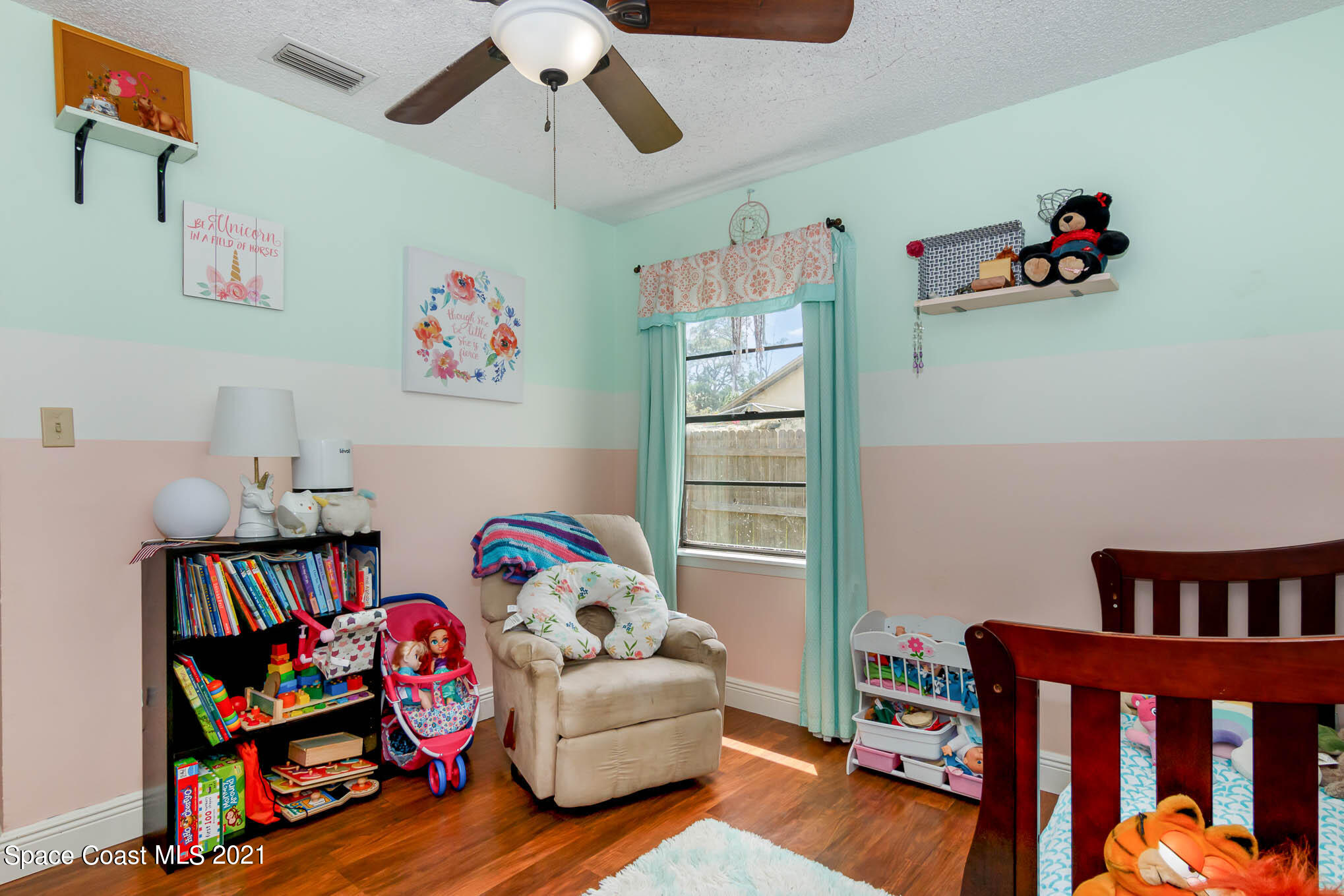 5617 Flint Road Cocoa, FL 32927 - Photo 19 of 25 a bedroom with furniture and a book shelf