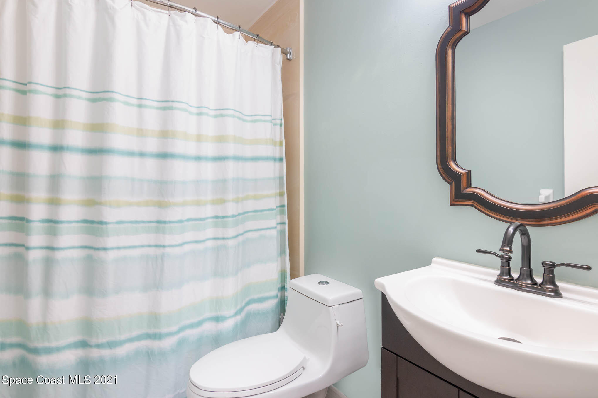 5617 Flint Road Cocoa, FL 32927 - Photo 20 of 25 a bathroom with a sink toilet and shower