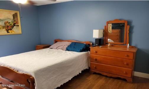 5617 Flint Road Cocoa, FL 32927 - Photo 21 of 25 a bedroom with a bed and a lamp on dresser