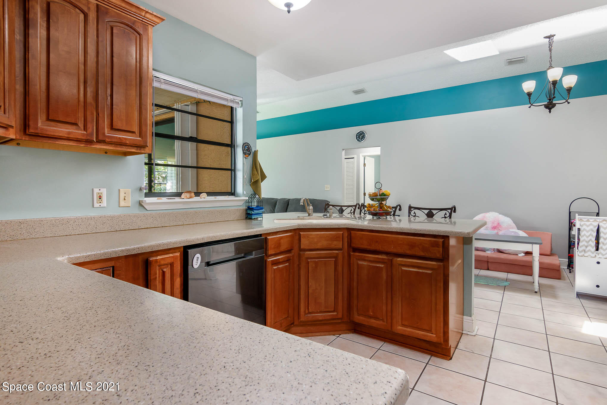 5617 Flint Road Cocoa, FL 32927 - Photo 6 of 25 a kitchen with stainless steel appliances granite countertop a sink wooden cabinets and a granite counter top