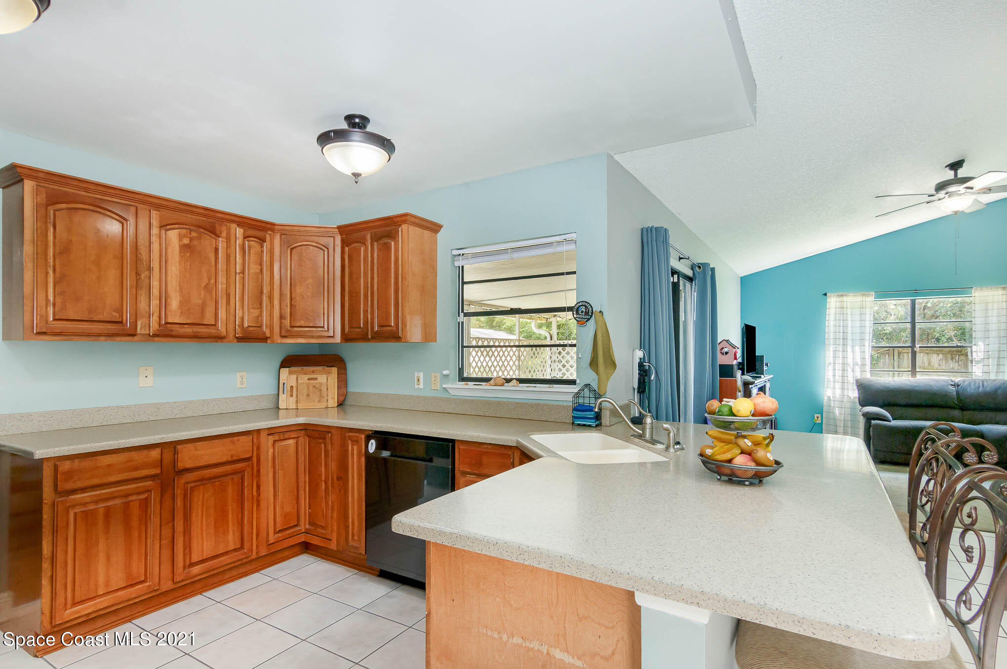 5617 Flint Road Cocoa, FL 32927 - Photo 7 of 25 a kitchen with wooden cabinets and sink
