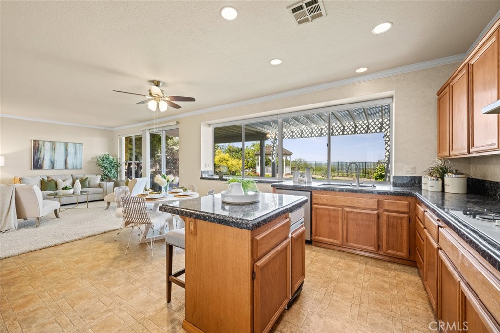 5118 Avenida De La Plata Oceanside, CA 92057 - Photo 12 of 42 a kitchen with stainless steel appliances granite countertop a stove and cabinets