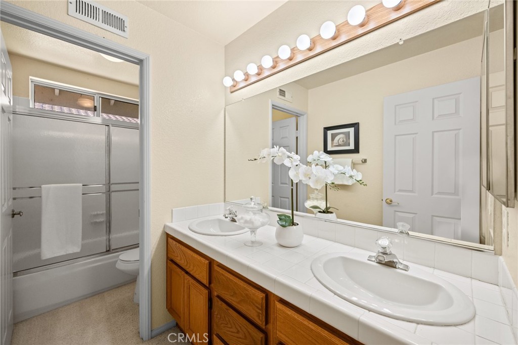 5118 Avenida De La Plata Oceanside, CA 92057 - Photo 28 of 42 a bathroom with a sink and a mirror