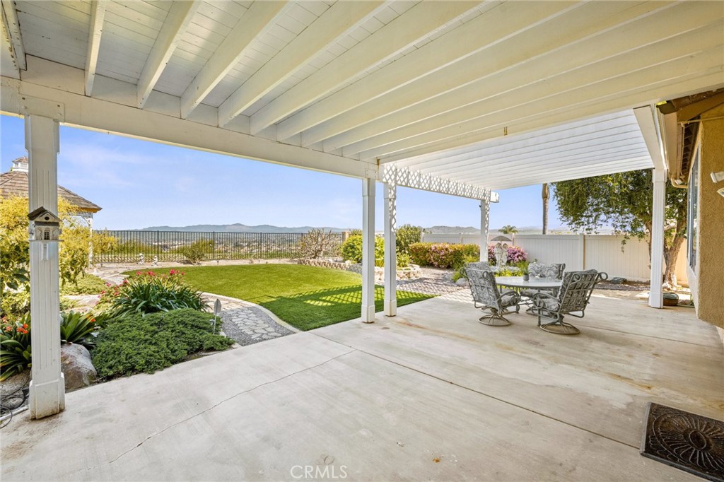 5118 Avenida De La Plata Oceanside, CA 92057 - Photo 29 of 42 a view of a patio with a table chairs and a patio