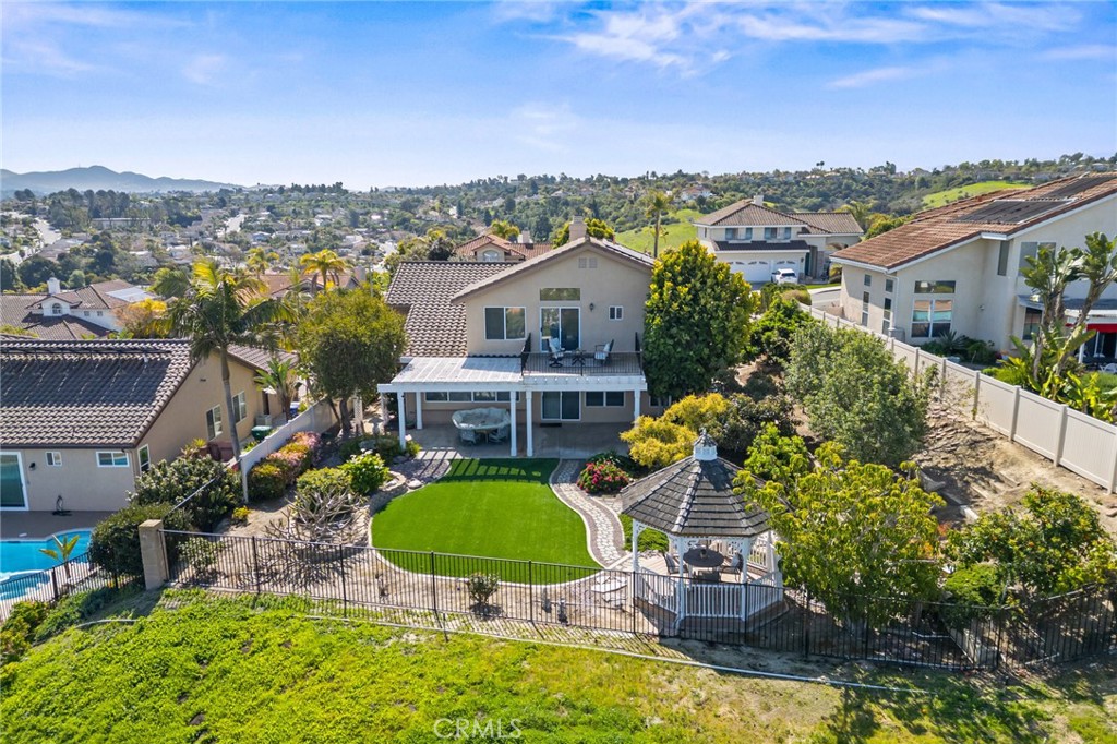5118 Avenida De La Plata Oceanside, CA 92057 - Photo 37 of 42 a view of a house with a swimming pool and a yard