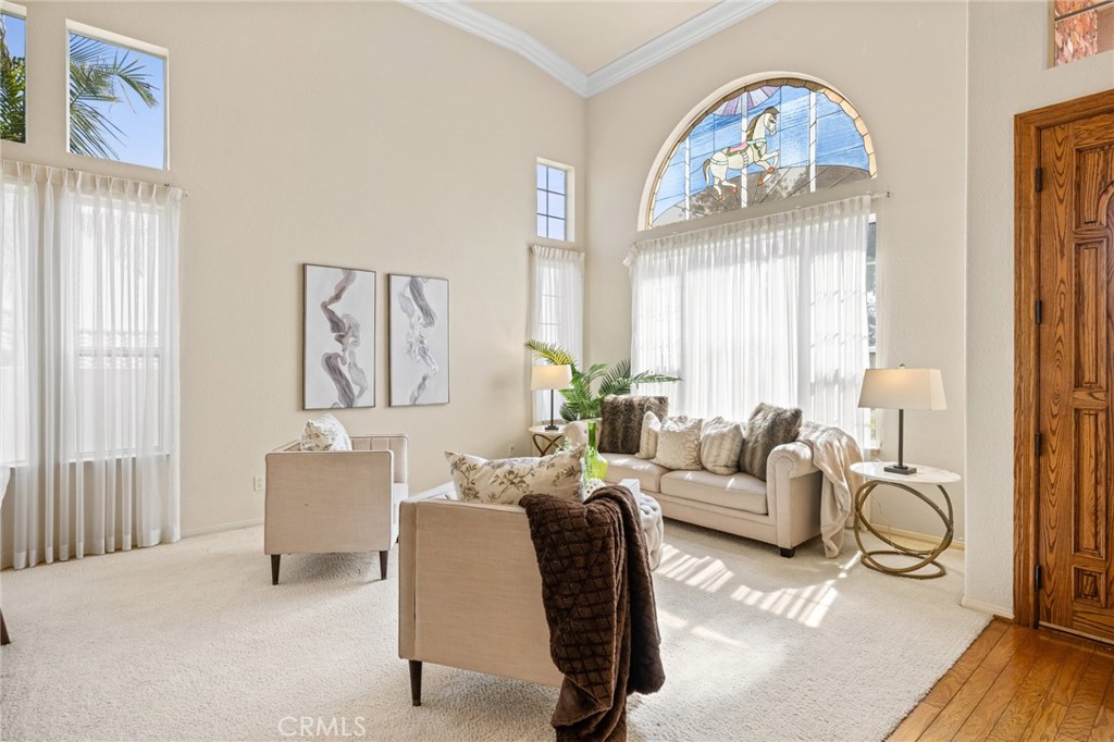 5118 Avenida De La Plata Oceanside, CA 92057 - Photo 5 of 42 a living room with furniture a fireplace and a chandelier