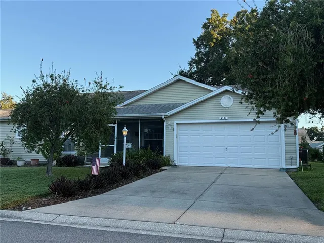 a front view of house with garage and yard