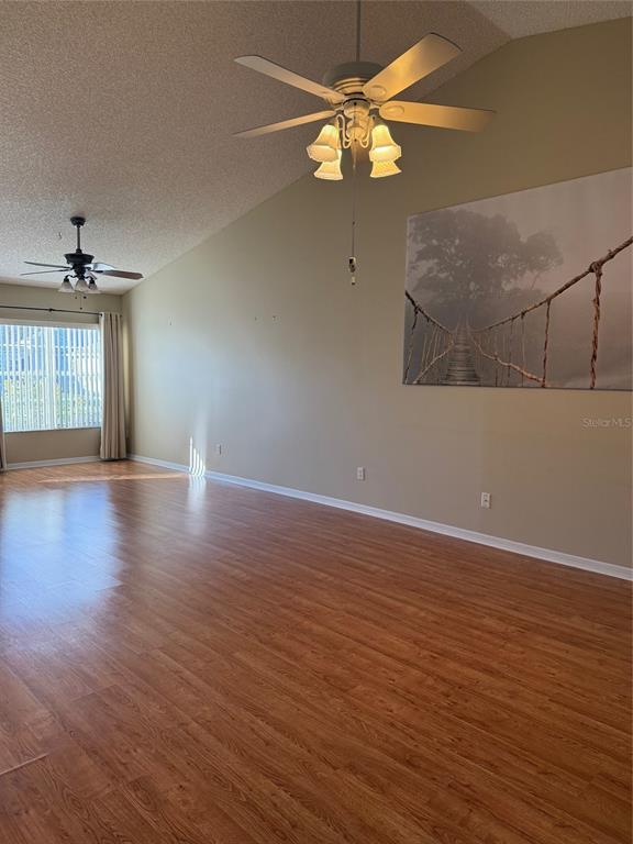 4501 River Ridge Drive Leesburg, FL 34748 - Photo 11 of 16 an empty room with wooden floor fan and window