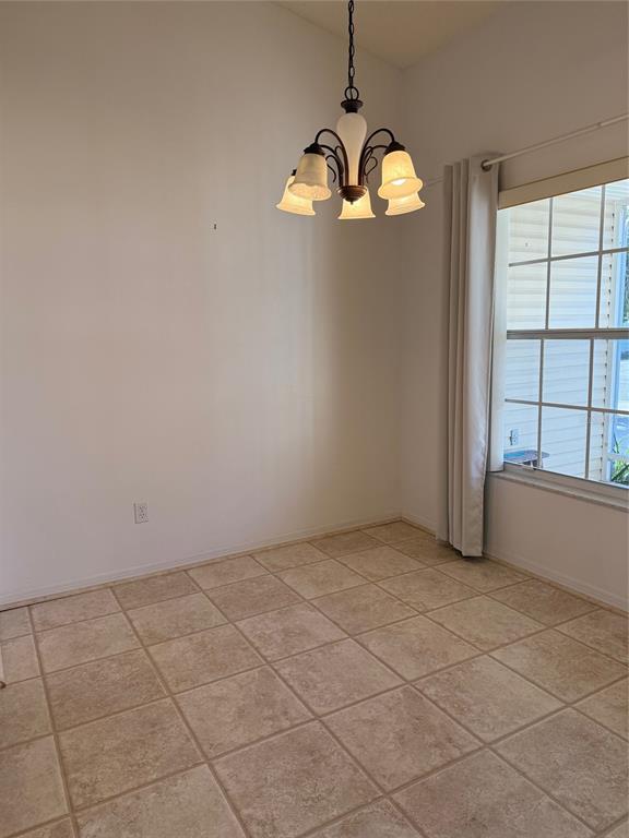 4501 River Ridge Drive Leesburg, FL 34748 - Photo 2 of 16 an empty room with windows and chandelier