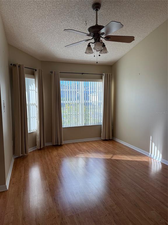 4501 River Ridge Drive Leesburg, FL 34748 - Photo 3 of 16 a view of an empty room with wooden floor and a window