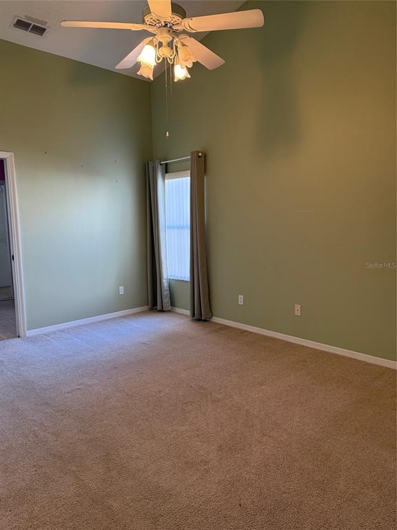 4501 River Ridge Drive Leesburg, FL 34748 - Photo 10 of 16 an empty room with a fan and a fan